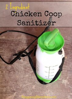 the chicken coop sanitizer is sitting on top of a wooden table next to a green cup