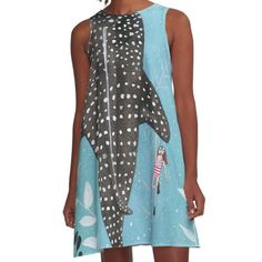 a woman wearing a dress with an image of a shark on it