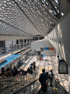 people are walking up and down an escalator