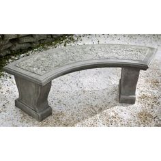 a stone bench sitting on top of snow covered ground