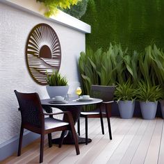 an outdoor table and chairs on a wooden floor next to a wall with green plants