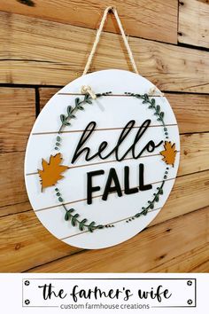 a sign that says hello fall hanging on a wall