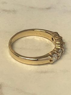 A beautiful Classic 14kt Yellow Gold Lady's Diamond Wedding/Anniversary/Stackable Band consisting of 5- full cut round brilliant diamonds .90ct total weight. All diamonds are SI1 clarity, G color and shared prong set in 4mm wide mounting in finger size 7 3/4. This style band would make a GREAT stackable band also. This item would Retail for $ 6,770.00 Diamond Wedding Anniversary, Stackable Bands, Brilliant Diamond, Gold Hoop, Mens Wedding Bands, Gold Hoop Earrings, Wedding Men, Diamond Wedding, Round Brilliant