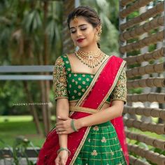 a woman wearing a green and red lehenga