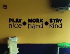 the play work stay nice hard kind wall decal is in black on a yellow wall