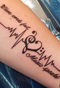 a heartbeat tattoo with music notes on it