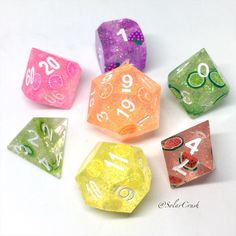 seven different colored dices with numbers on them