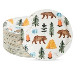 a stack of paper plates with bears and trees on them