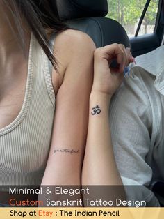 two people sitting in a car with tattoos on their arm and wrist, one is holding an ink pen