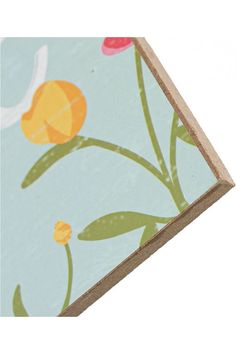 a close up of a piece of paper with flowers on it and an orange flower in the center