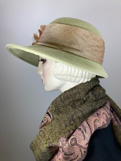 This hat would be right at home on Downton Abbey! The color is a really pretty pistachio green. It is topped with a light tan silk band that coordinates perfectly! Embellished with three vintage silk and velvet flowers. The brim shape is a soft oval and the sides are longer than the front; the back is much narrower at 2 1/4 inches. It is hand blocked using traditional millinery techniques, including steaming, shaping, and hand sewing. ++++++++++++++++++++++++++++++++++++++++++++++++++++++FIT AND London In March, Downton Abbey Style, Downton Abbey Fashion, Tan Silk, Elegant Hats, Velvet Flowers, Warm Winter Hats, Dress Appropriately, Pistachio Green