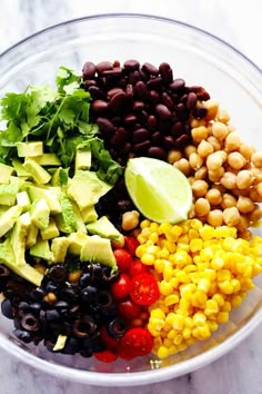 an image of a salad in a bowl with corn, avocado and tomatoes