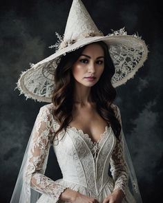 a woman wearing a white wedding dress and a large hat with lace on the sides