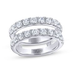 a white gold wedding ring set with three rows of round cut diamonds on each band