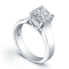 a princess cut diamond engagement ring on a white background