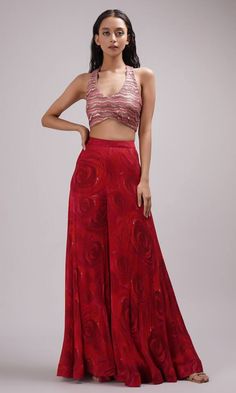 Red halter neck crop top with sequin embroidery. Paired with a rose print sharara and dupatta. - Aza Fashions Bollywood Style Red Sharara For Evening, Red Bollywood Style Sharara For Evening, Red Bollywood Sharara For Evening, Red Party Wear Sets With Unstitched Blouse, Fitted Red Sharara For Evening, Red Party Wear Sets For Festive Occasions, Red Party Sets With Zari Work, Festive Red Party Wear Sets, Festive Red Evening Sets