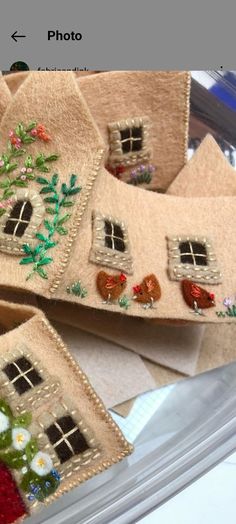 two handmade houses are on display in a case