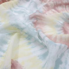 a tie dyed fabric with pastel colors