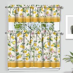 a window curtain with lemons and flowers on it