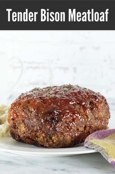 tender bison meatloaf on a plate with mashed potatoes