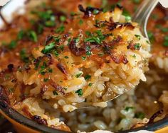 a close up of a spoon full of rice and meat with parsley on top