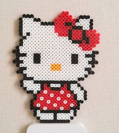 the hello kitty is made out of legos and has a red bow on it