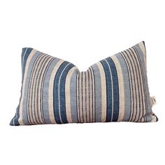 a blue and white striped pillow on a white background