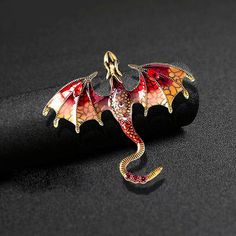 Unleash the mystique and power of the dragon with the exquisite "Dragon" Lapel Pin. Crafted with utmost precision and meticulous attention to detail, this lapel pin is a testament to refined craftsmanship and sophisticated style. Made from high-quality zinc alloy and adorned with sparkling glass stones, it embodies the fierce and captivating allure of this mythical creature. The "Dragon" Lapel Pin is available in a range of colors, allowing you to choose the perfect embodiment of your personal s Dragon Brooch, Flying Dragon, School Bookbags, Vintage Dragon, Black Tie Affair, Perfect Gif, Casual Accessories, Red Dragon, Scarf Hat