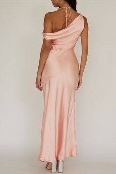 a woman in a pink dress with one shoulder open