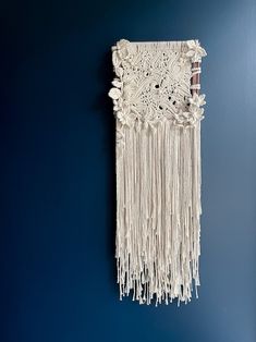 a white wall hanging on the side of a blue wall