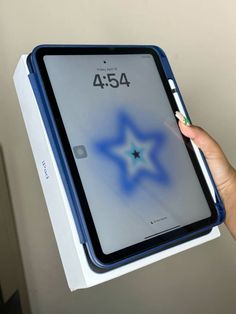 a person holding an ipad in their left hand with the display on it's back