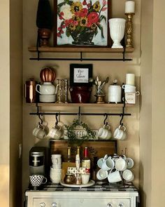 an old fashioned stove with pots and pans on it's shelf in a kitchen