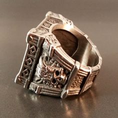 Fenris Skull Tomb Ring Silver Silver biker rocker style skull ring with gothic architectural details, black crystals.Metal: Silver alloySize: 10 Includes velvet gift bag. Need a gift box? We have those too! Black Metal Skull Ring Symbolic Style, Symbolic Black Metal Skull Ring, Black Metal Skull Ring Gift, Black Metal Skull Ring As Gift, Black Metal Skull Ring For Gift, Punk Style Black Skull Ring Gift, Collectible Gothic Skull Ring, Gothic Metal Skull Ring Gift, Gothic Skull Ring Metal Gift