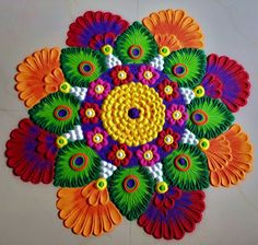 an intricately designed design on the floor is made with colorful threads and beads