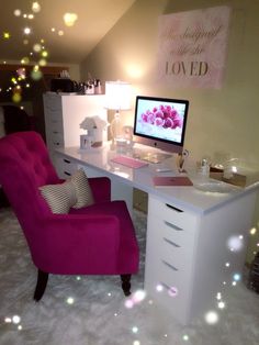 a pink chair sitting in front of a computer desk