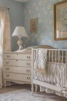 a baby's crib in the corner of a room with flowers on the wall