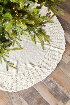 a christmas tree skirt on top of a wooden floor