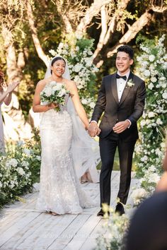 a bride and groom walking down the aisle after their wedding ceremony at an outdoor venue