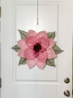 a white door with a pink flower on it