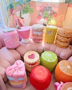 there are many different types of cakes on the couches and in the background is a vase with flowers