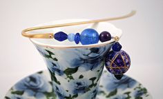 a tea cup with some beads on it