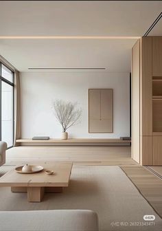 a living room filled with lots of furniture and a large window next to the wall