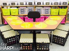 a table and four chairs in front of shelves with bins on the floor next to it