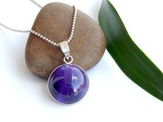 "Silver chain can be included with an extra charge of 30 USD. Amethyst Designer Pendant. Exquisite Pendant is beautifully and Traditionally Hand Crafted into a beautiful design.  Stone: Amethyst Material : 925 Sterling Silver (1 gram approx.) Total Weight: 10.44 grams approx. Stone Shape: circular Shape  Stone Setting: Bezel Setting  Product is handmade with pure 925 Sterling silver.  Genuine/Natural gemstones were used. We don't deal with laboratory generated stones.  Please understand that the natural gemstone is unique and may vary in shape or color.  Photos were taken in natural light for the listed item. However, since screen resolutions may vary, the colors \"in-person\" may be slightly different than you see on your monitor.   Any Queries and questions are most welcome. We will answ Purple Cabochon Round Necklace, Purple Round Cabochon Necklace, Amethyst Cabochon Necklace For Gift, Purple Cabochon Gemstones For Gift, Purple Necklace With Polished Finish As Gift, Amethyst Cabochon Gemstones For Gift, Round Purple Gemstones As A Gift, Round Purple Gemstones For Gifts, Round Purple Gemstones As Gifts