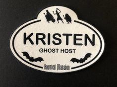 a white and black sticker with the words kristen ghost host written on it