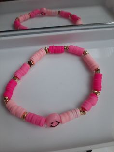 Heishi Clay Bracelet made with three shades of pink with a spacer bead with a smiley face to end it off the right way Bracelets Preppy, Face Clay, Preppy Bracelets, Clay Bead Bracelet, Fayetteville Nc, Clay Bracelet, Clay Bead, Heishi Beads, Clay Beads