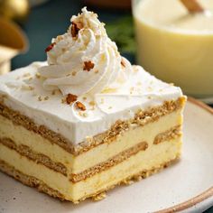 a piece of cake sitting on top of a plate next to a glass of milk