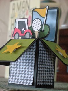 an origami golf card holder made out of construction paper and cut outs with scissors