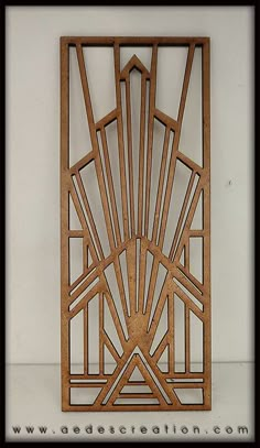 an art deco sculpture made out of wood with geometric designs on the front and sides