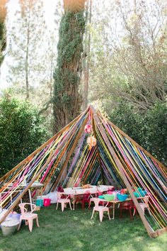 a colorfully decorated teepee with chairs and tables